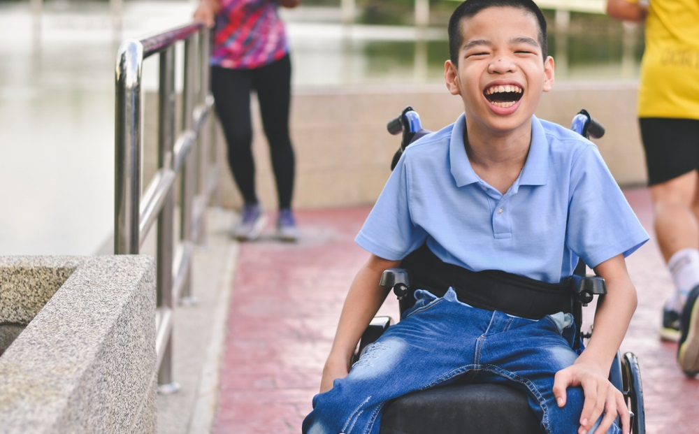 Child in wheelchair laughing