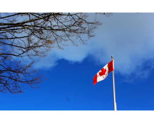 Canadian flag against blue sky