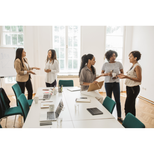 Women around office table talking