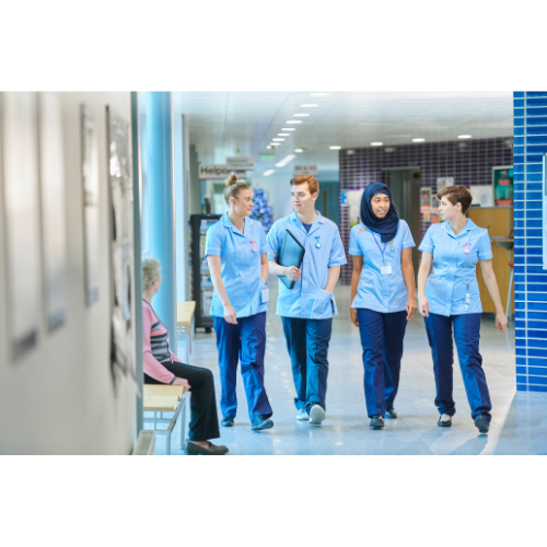 4 nurses in hospital hallway