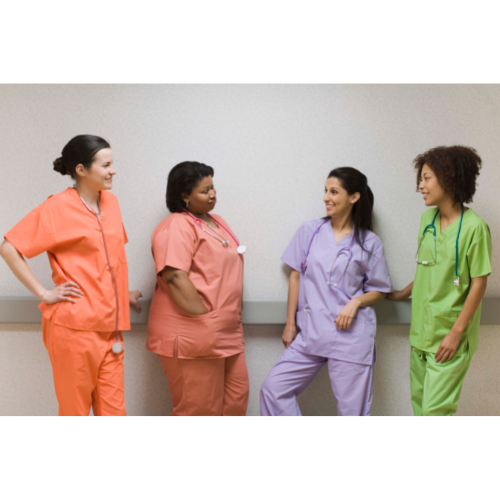 Group of 4 nurses in different-colored scrubs standing and talking