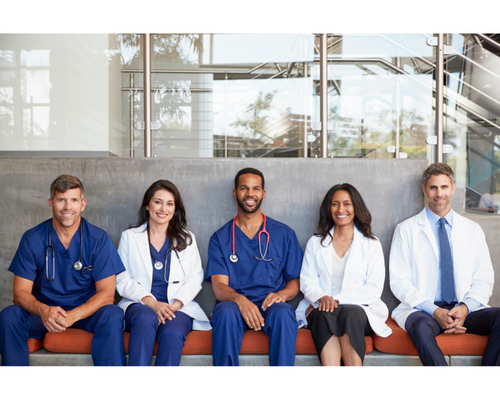 Photo of five healthcare workers sitting down on a bench