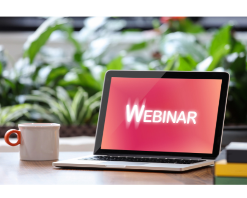 Photo of laptop with the word "webinar" on a red background