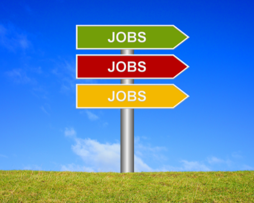 Photo of colorful 3 arrows saying "Job" on a green field