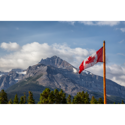 Canadian flag with mountain range view in background