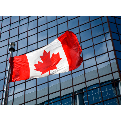 Canadian flag against glass building