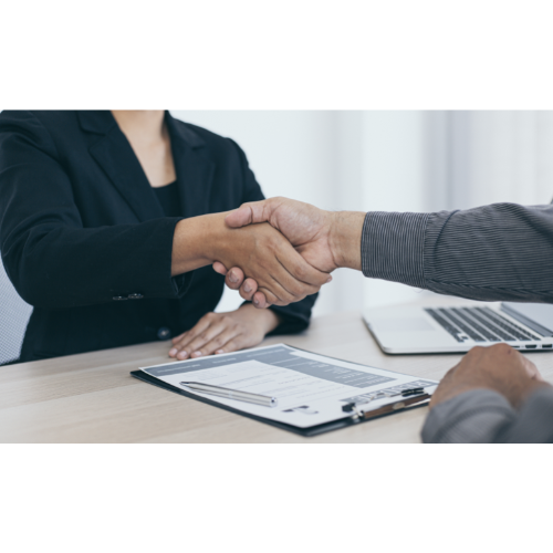 Job interview applicant shaking hands with hiring manager