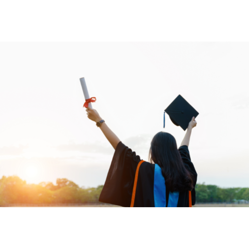 Person in graduation gown with arms outstretched looking at the sky and holding diploma